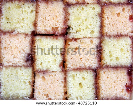 A close up of a cross-section of a Battenburg sponge cake