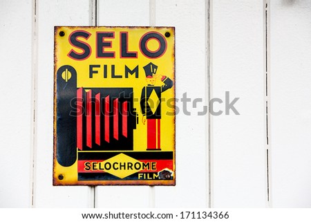 NR SOUTHAMPTON,UK - 25 June 2013: Old style tin advertising board for Selo film displayed on painted wood with space for text. On 25 June 2013 Near Southampton UK