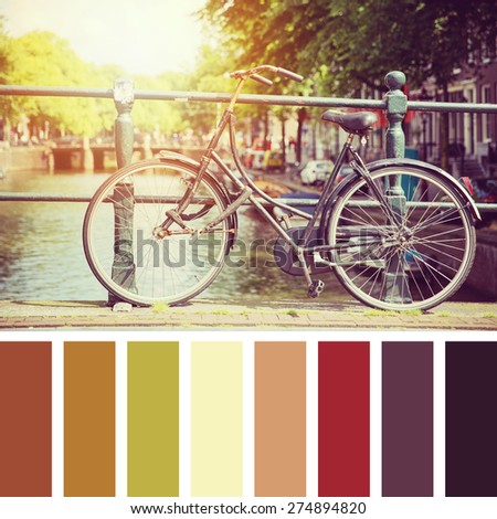 Bicycle on a bridge in sunlight, Amsterdam. In a colour palette with complimentary colour swatches.