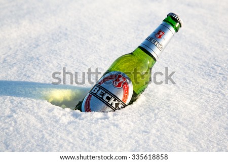 MONTREAL, CANADA -21 January 2015: A bottle of Beck\'s beer cools in the winter snow. Beck\'s is the bestselling German beer in the world. In Montreal, january 2015