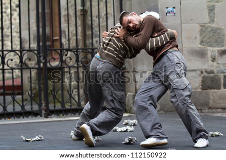 AURILLAC, FRANCE - AUGUST 24: two masked dancers fight in the street as part of the Aurillac International Street Theater Festival,show by the Company Idem,on august 24, 2012, in Aurillac,France.