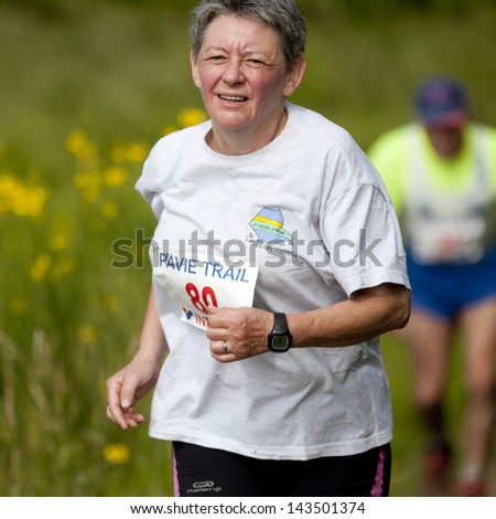 PAVIE, FRANCE - JUNE 23: Old female runner at the Trail of Pavie, on June 23, 2013, in Pavie, France.
