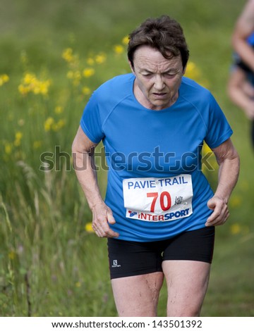 PAVIE, FRANCE - JUNE 23: Elderly female runner at the Trail of Pavie, on June 23, 2013, in Pavie, France.