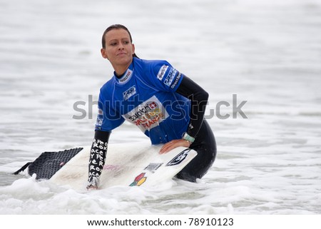 SEIGNOSSE, FRANCE - JUNE 3: An unidentified female surfer at the end of her contest at the Swatch Pro France on June 3, 2011 in Seignosse, France.