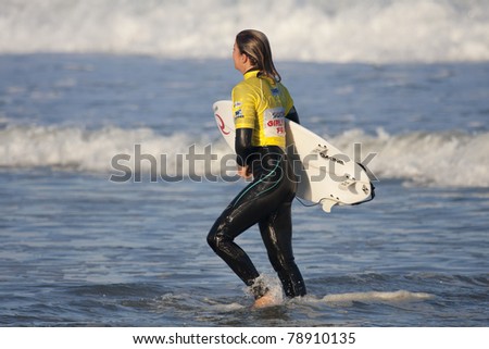 SEIGNOSSE, FRANCE - JUNE 3: Surfer Cannelle Bulard walks in the water after her contest at the Swatch Pro France on June 3, 2011 in Seignosse , France.