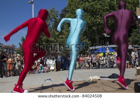 AURILLAC, FRANCE- AUGUST 17:  Three unidentified dancers move in the street as part of the Aurillac International Street Theater Festival, Cie 