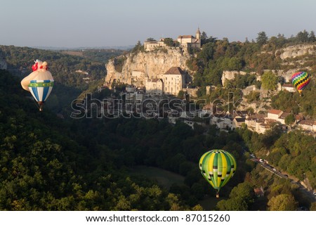 ROCAMADOUR, FRANCE- SEPTEMBER 25: Three hot air balloons ascending at sunrise for the 26ème Montgolfiades de Rocamadour, on September 25, 2011 in Rocamadour, France.