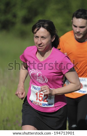 PAVIE, FRANCE - MAY 18:  Motivated mature woman who runs at the Trail of Pavie, on May 18, 2014, in Pavie, France