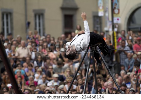AURILLAC, FRANCE-AUGUST 22: balancing act in front of a big crowd as part of the Aurillac International Street Theater Festival, cie teatro del silencio ,on august 22, 2014, in Aurillac,France.