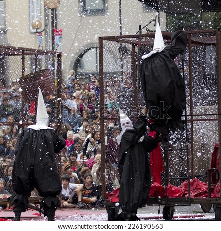 AURILLAC, FRANCE-AUGUST 22: disguised people move under the snow as part of the Aurillac International Street Theater Festival, cie teatro del silencio there august 22, 2014 in Aurillac, France.