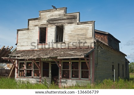 Derelict rural store with a raven