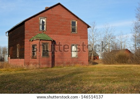 Abandoned farmhouse.  Surrounding yard is still kept mowed and house in good condition