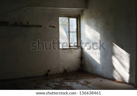 Old empty abandoned room with sunlight shining through the window