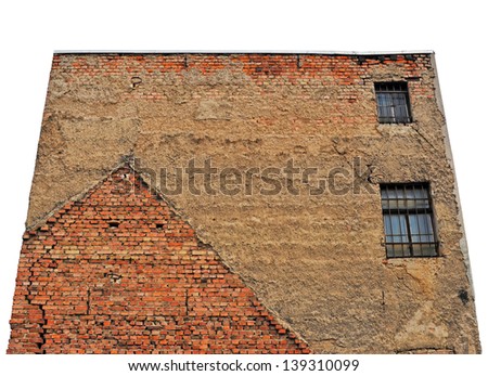 Old grungy face of a building with brick-wall and two windows