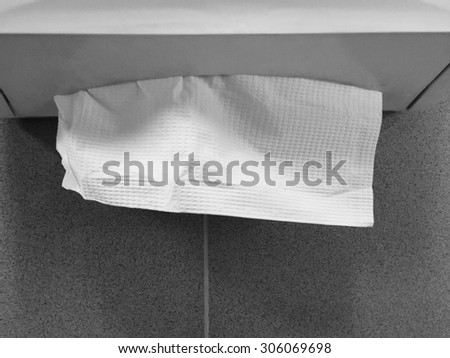 napkin paper towel dispenser on the wall in the bathroom with black and white processed