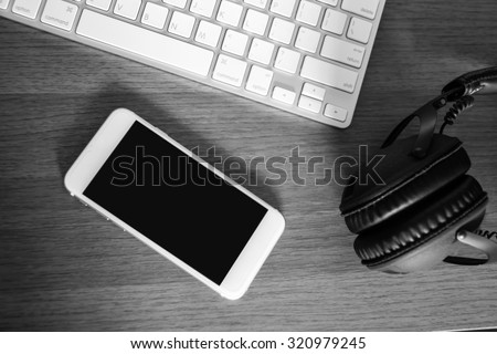 Stereo headphones ,mobile phone and the keyboard of a computer
