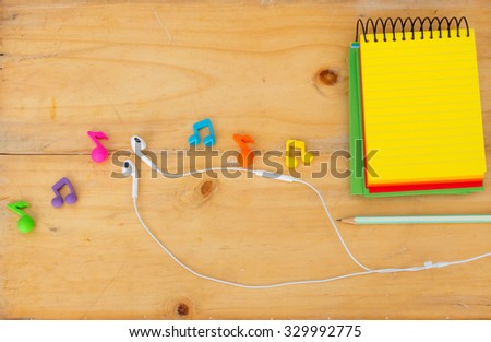 song writer desktop with music note,earphones , notebook and pencil