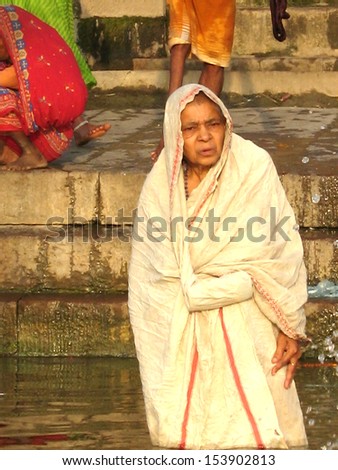 VARANASI, INDIA - 10 JULY: People wade in water during a religious ceremony at Uttar Pradesh on July 10, 2007 in Varanasi, India.