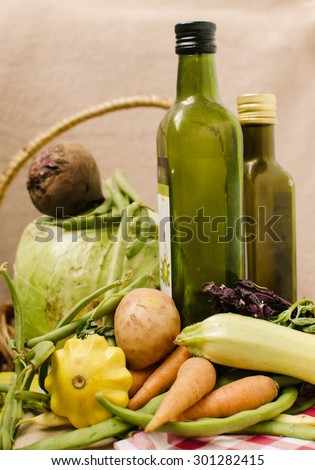 fresh organic vegetables from the farm on the table with bottles of oil