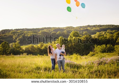 happy family lets balloons in the sky