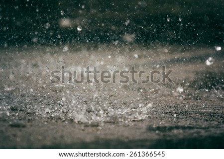 Heavy rain drops on asphalt.