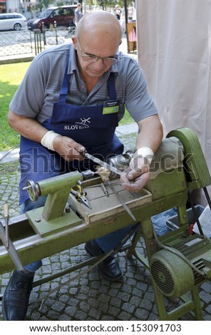 BRATISLAVA, SLOVAKIA - AUGUST 31, 2013 - The craftsman is working-out the cast brast bells during Festival Craftsmen Days  August 31th 2013 in Bratislava.