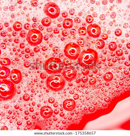 closeup of soap bubbles, white lather, red background