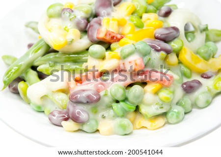 A small white bowl with a serving of edamame salad.