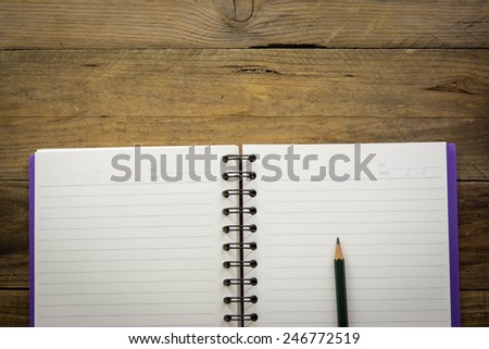 Paper Note Book on Wooden Table Rustic Style / write down your text here, background and texture.