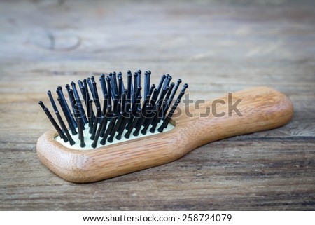wooden comb on a wood background