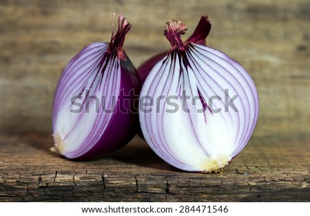 cut red onion on wooden background