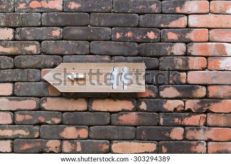 Vintage Toilet Sign On Old Brick Wall