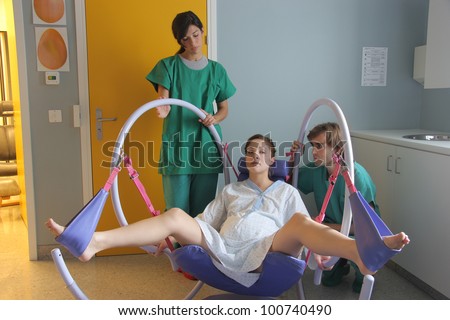 Two doctors and a pregnant woman in a delivery room