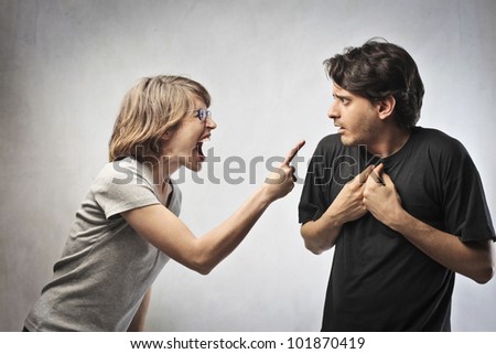Angry woman pointing her finger against her husband
