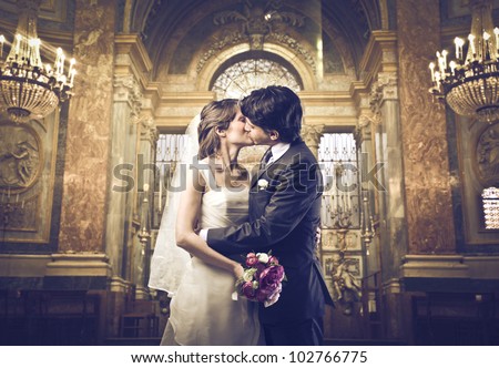 Married couple kissing in a church