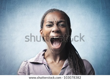 Angry young african woman screaming
