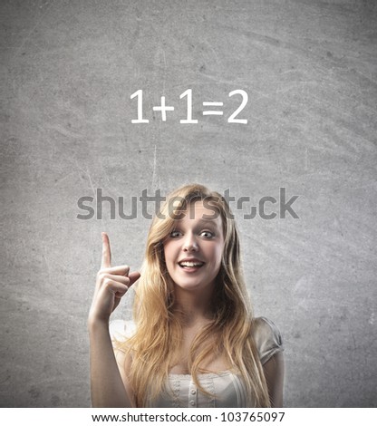 Smiling young woman finding the solution to the easy calculation over her head
