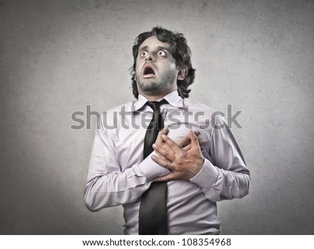 Businessman with painful expression having a heart attack