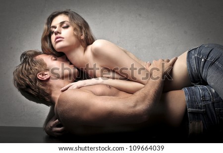 Young handsome man kissing his girlfriend\'s neck