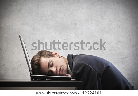 Businessman sleeping on his laptop