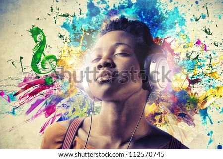 Black girl listening to the music with a pair of headphones Black girl listening to the music with a pair of headphones