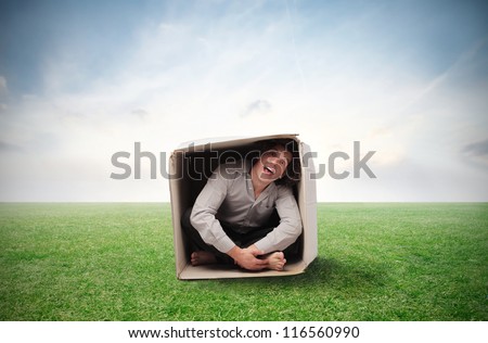 Man compressed in a box