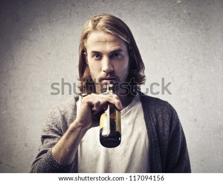 Blonde guy drinking a beer
