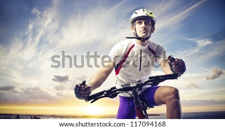 Man with a bicycle on a sunset Man with a bicycle on a sunset