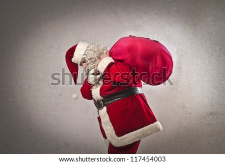 Santa Claus holding the bag with the presents