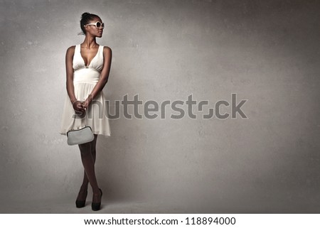 Beautiful black girl with a white dress posing