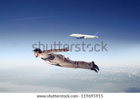 Businessman flying near an airliner