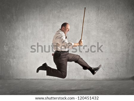 Fat man with a stick running after someone
