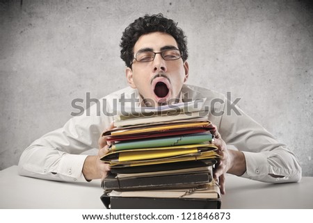 Yawning office worker with a lot of work