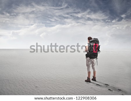 Guy with a travel backpack in a fake desert